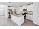 Bright kitchen features an island, stainless steel appliances, and white cabinets at 437 Lazy Shore Dr, Nokomis, FL 34275