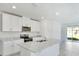 Modern kitchen boasts a center island, stainless steel appliances, and granite countertops at 437 Lazy Shore Dr, Nokomis, FL 34275
