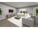 Spacious living room features gray wood floors, recessed lighting, and neutral furniture at 461 Sun Chaser Dr, Nokomis, FL 34275