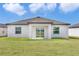 Home's rear exterior with a spacious lawn at 10008 Last Light Gln, Parrish, FL 34219