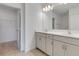 Bathroom featuring double sink vanity and closet at 10008 Last Light Gln, Parrish, FL 34219