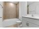 Well-lit bathroom with a shower-tub combo and modern vanity with a sink at 10008 Last Light Gln, Parrish, FL 34219