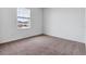 Cozy bedroom featuring neutral carpet and a window with natural light at 10008 Last Light Gln, Parrish, FL 34219