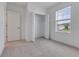 Comfortable bedroom with carpet, closet, and natural light streaming through the window at 10008 Last Light Gln, Parrish, FL 34219