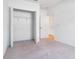 Bright bedroom with carpet, closet, and an open doorway to a neighboring room at 10008 Last Light Gln, Parrish, FL 34219
