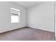 Neutral bedroom featuring soft carpet, a window, and ample natural light at 10008 Last Light Gln, Parrish, FL 34219
