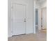 Hallway leading to a bedroom featuring a closet, and a view to a second bedroom with hard surface flooring at 10008 Last Light Gln, Parrish, FL 34219