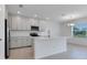 Well-lit kitchen featuring an island, stainless steel appliances, and white subway tile backsplash at 10008 Last Light Gln, Parrish, FL 34219