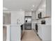 Modern kitchen with white cabinets, stainless steel appliances, and quartz countertops at 10008 Last Light Gln, Parrish, FL 34219