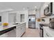 Modern kitchen with stainless steel appliances, white cabinetry, and a stylish countertop island at 10008 Last Light Gln, Parrish, FL 34219