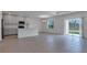Bright living room featuring tile flooring, an open layout, and access to outdoor patio at 10008 Last Light Gln, Parrish, FL 34219