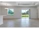 Bright living room showcasing an open floorplan, large windows, and access to the backyard at 10008 Last Light Gln, Parrish, FL 34219