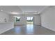 Open-concept living area with tile flooring and sliding glass doors leading to the outdoors at 10008 Last Light Gln, Parrish, FL 34219