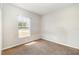 Bedroom with neutral walls and carpet features a window providing natural light at 2174 Brubeck Rd, North Port, FL 34287