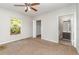 Bedroom with neutral walls, ceiling fan, closet, and an ensuite bathroom at 2174 Brubeck Rd, North Port, FL 34287