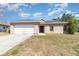 Charming single-story home with a two-car garage and a well-manicured front lawn at 2174 Brubeck Rd, North Port, FL 34287