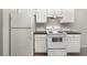 Clean kitchen with white appliances, including a refrigerator and stove at 2174 Brubeck Rd, North Port, FL 34287