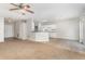 Open living space featuring a ceiling fan, neutral walls, and a view into the kitchen at 2174 Brubeck Rd, North Port, FL 34287