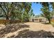 A spacious backyard with mature trees and a house in the background at 626 Belleview Blvd, Clearwater, FL 33756