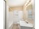 Bright bathroom featuring a tiled shower/tub, vanity, and window with blinds at 626 Belleview Blvd, Clearwater, FL 33756