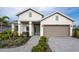Charming two-story home with a two-car garage, beautifully landscaped front yard, and a welcoming walkway at 9548 Vibrant Lane, Venice, FL 34292
