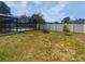 Well-sized backyard with a fire pit area and views of the screened pool enclosure at 22162 Weeks Blvd, Land O Lakes, FL 34639