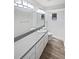 Clean bathroom with modern vanity, large mirror with lighting, and updated fixtures at 22162 Weeks Blvd, Land O Lakes, FL 34639