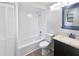 Bathroom features a shower-tub, toilet, and vanity with a dark wood cabinet at 22162 Weeks Blvd, Land O Lakes, FL 34639