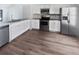 Bright kitchen with stainless appliances, light countertops, and new cabinets with tile backsplash at 22162 Weeks Blvd, Land O Lakes, FL 34639