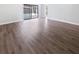 Spacious living room with wood-look floors and sliding doors to the backyard at 22162 Weeks Blvd, Land O Lakes, FL 34639