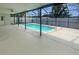 A screened pool area featuring a serene pool, and a spacious seating area at 22162 Weeks Blvd, Land O Lakes, FL 34639