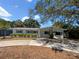 Charming single-story home with a well-maintained lawn and mature landscaping at 4825 W Bay Court Ave, Tampa, FL 33611