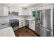 Modern kitchen features stainless steel appliances, white cabinets, and light countertops at 4825 W Bay Court Ave, Tampa, FL 33611