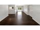 Bright, open-concept living area features dark wood floors and sliding glass doors to the backyard at 4825 W Bay Court Ave, Tampa, FL 33611