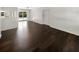Bright, open-concept living area features dark wood floors and sliding glass doors to the backyard at 4825 W Bay Court Ave, Tampa, FL 33611