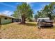 Spacious backyard featuring a large tree, storage shed, and boat trailer, perfect for outdoor activities and storage at 5208 30Th W St, Bradenton, FL 34207