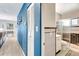 Hallway leading to a bathroom with a shower, toilet, and white and black tile at 5208 30Th W St, Bradenton, FL 34207