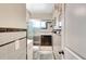 Cozy bathroom with white and black tiles, a glass-enclosed shower, and white cabinets at 5208 30Th W St, Bradenton, FL 34207