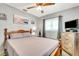 Cozy bedroom featuring a wooden bed frame, ceiling fan, and ample natural light from the window at 5208 30Th W St, Bradenton, FL 34207