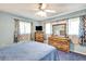 Bright bedroom featuring blue walls, carpet, dresser, and natural light from windows at 5208 30Th W St, Bradenton, FL 34207