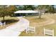 Inviting home with a long driveway, partial fencing, and mature trees providing ample shade and curb appeal at 5208 30Th W St, Bradenton, FL 34207