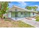 Single-story home featuring a covered front porch, well-maintained lawn, and classic architectural design at 5208 30Th W St, Bradenton, FL 34207