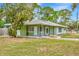 Charming single-story home featuring a covered porch, well-manicured lawn, and classic architectural details at 5208 30Th W St, Bradenton, FL 34207