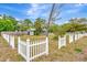 Quaint home surrounded by a charming white picket fence and lush green lawn at 5208 30Th W St, Bradenton, FL 34207