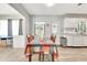 Bright eat-in kitchen with gray walls, white cabinets, and a colorful tablecloth on the table at 5208 30Th W St, Bradenton, FL 34207