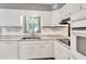 Clean kitchen with a dual-basin sink, white cabinets, and modern fixtures at 5208 30Th W St, Bradenton, FL 34207