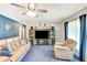 Bright living room with a comfortable sofa set and a modern entertainment center at 5208 30Th W St, Bradenton, FL 34207