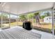 Enclosed back patio with a neutral color scheme, patio furniture, and views of the surrounding greenery at 5208 30Th W St, Bradenton, FL 34207