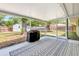 Enclosed back patio with a neutral color scheme, patio furniture, and views of the surrounding greenery at 5208 30Th W St, Bradenton, FL 34207