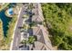 Aerial view of a residential community featuring well-maintained landscaping, pool, and charming homes at 8035 St Simons St # 8035, University Park, FL 34201